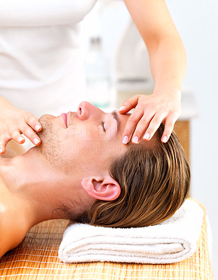 Woman giving happy man face massage