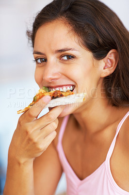 Young woman eating pizza