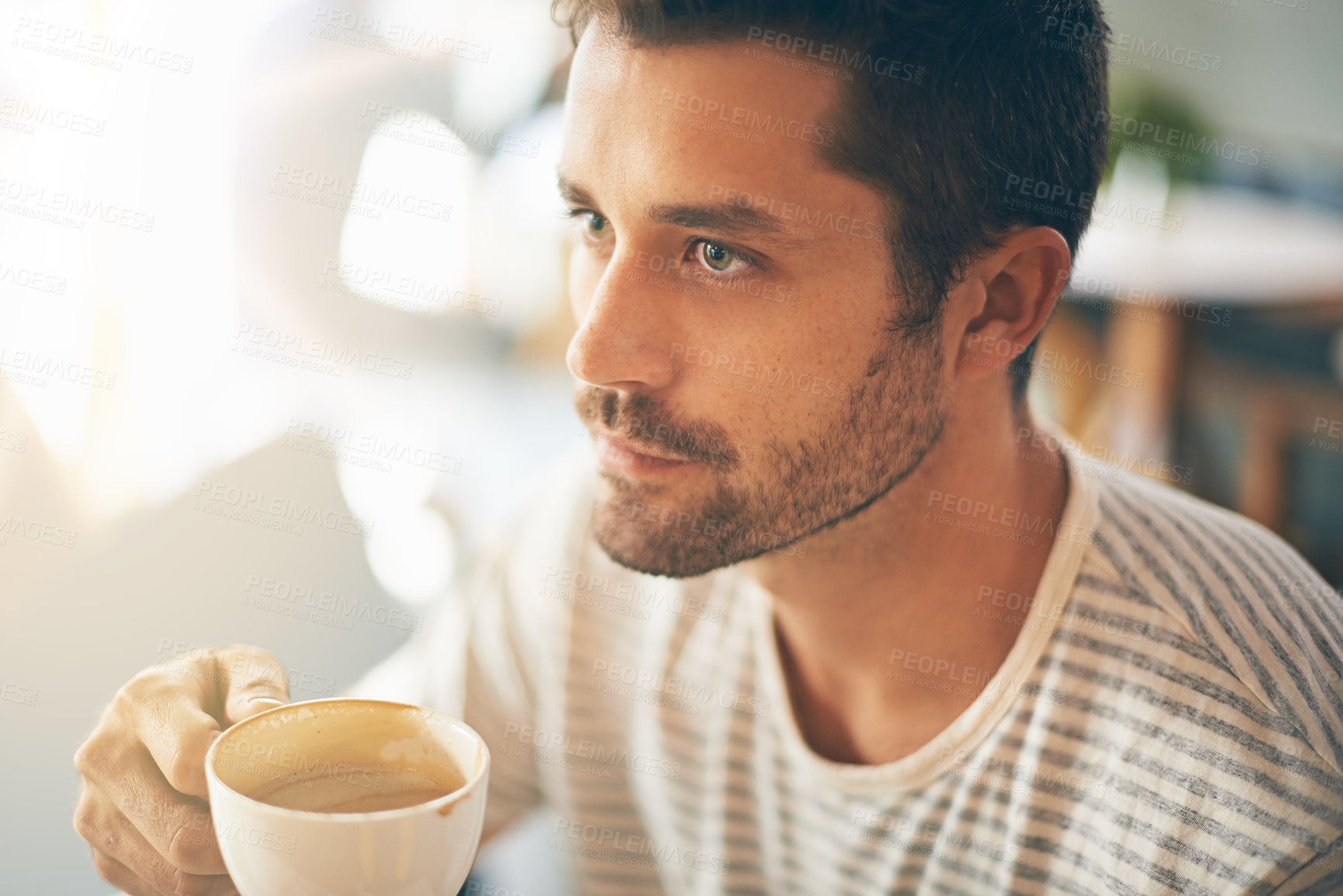 Closeup shot of a young man having a cup of coffee at a cafe - stock photo ...