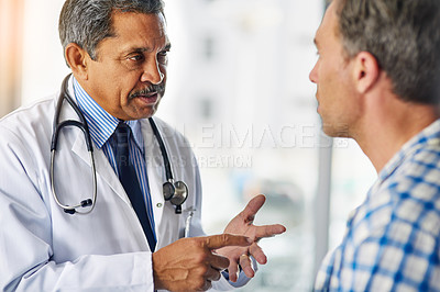 Buy stock photo Cropped shot of a doctor a giving his patient advice during a consult