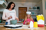 Teaching her daughter the baskics of baking