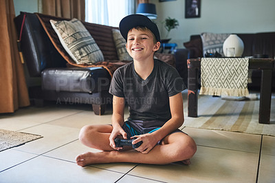 Buy stock photo Full length portrait of a young boy playing video games at home