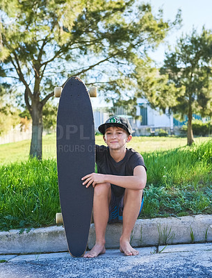 Buy stock photo Full length portrait of a young boy sitting on the curb with his longboard