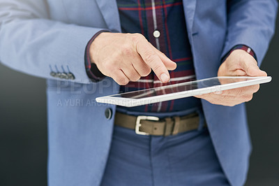 Buy stock photo Closeup shot of a businessman working on a digital tablet