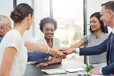 Buy stock photo Cropped shot of businesspeople joining their hands together in unity