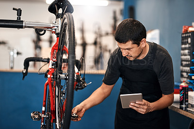 Managing his bicycle shop with modern tech