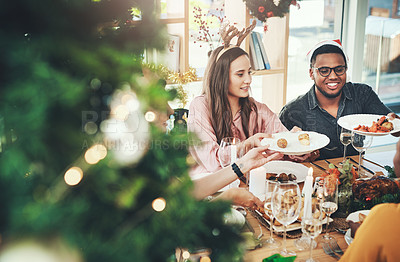 Pics of Cropped shot of a group of cheerful young friends having Christmas lunch together at home, stock photo, images and stock photography PeopleImages.com. Picture 2016245