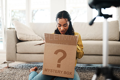 Pics of Cropped shot of an attractive young businesswoman sitting in her living room and vlogging her reaction to a mystery box, stock photo, images and stock photography PeopleImages.com. Picture 2016751