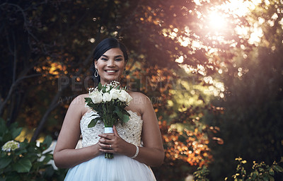 Buy stock photo Cropped shot of a young bride posing outside with her bouquet