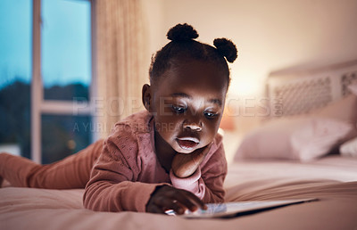 Buy stock photo Shot of a little girl using her digital tablet in her bedroom