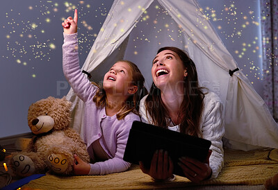Buy stock photo Shot of a little girl and her mother using a digital tablet before bedtime