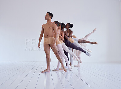 Buy stock photo Shot of a group of ballet dancers practicing a routine in a dance studio