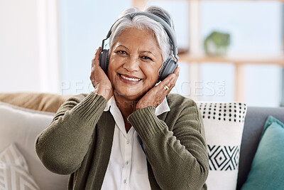 Buy stock photo Cropped portrait of an attractive senior woman listening to music at home