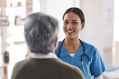 Buy stock photo Cropped shot of an attractive young female nurse talking to a senior patient