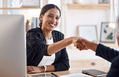 Buy stock photo Cropped shot of an attractive young businesswoman shaking hands with a colleague