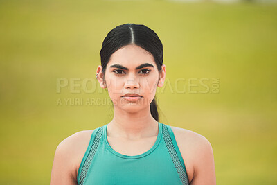 Buy stock photo Cropped portrait of an attractive young sportswoman standing outside against a green background