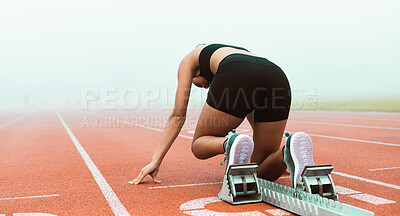 Buy stock photo Rearview shot of an unrecognizable young sportswoman taking her mark on starting blocks
