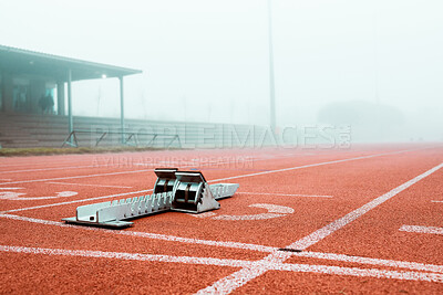 Buy stock photo Shot of metal starting blocks standing out on a running track