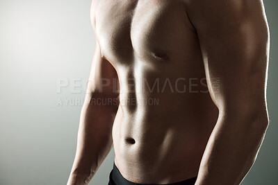 Buy stock photo Studio shot of a muscular man posing against a grey background
