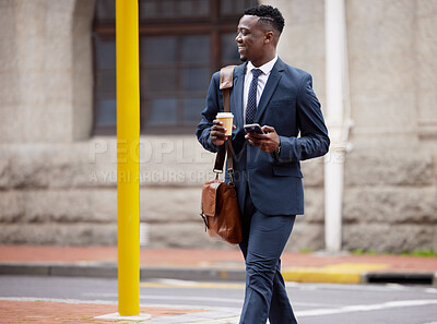Buy stock photo Shot of a young businessman using a phone in the city