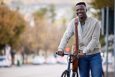 Buy stock photo Shot of a young businessman riding a bike in the city