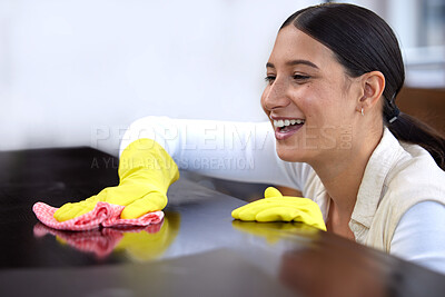 Buy stock photo Shot of a beautiful young woman cleaning a table