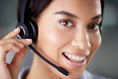 Buy stock photo Shot of an attractive young call centre agent wearing a headset in the office during the day