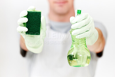 Buy stock photo Shot of an unrecognisable man holding cleaning spray and a sponge