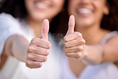 Buy stock photo Cropped shot of two unrecognisable women showing thumbs up outdoors