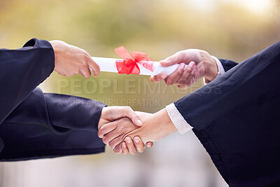 Buy stock photo Shot of two unrecognisable women exchanging certificates and shaking hands on graduation day