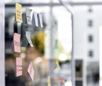Buy stock photo Closeup shot of sticky notes on a glass screen in an empty office