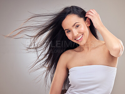 Buy stock photo Shot of an attractive young woman posing alone in the studio with her hair blowing in the wind