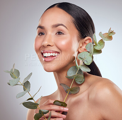 Buy stock photo Studio shot of a beautiful young woman posing with eucalyptus against a grey background