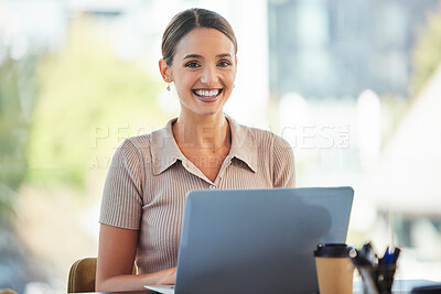 Buy stock photo Shot of a young businesswoman using her laptop at work