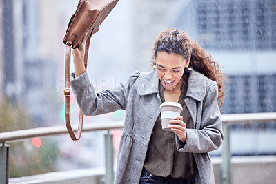 Buy stock photo Shot of a young businesswoman carrying a coffee cup in the rain