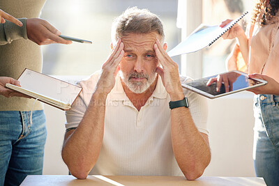 Buy stock photo Shot of a mature businessman looking stressed and frustrated in a meeting at work