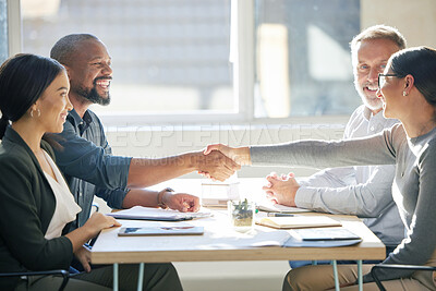 Buy stock photo Cropped shot of two businesspeople shaking hands during a meeting in the boardroom