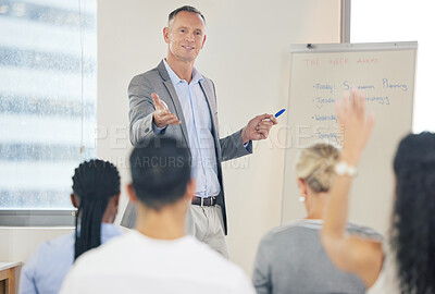 Buy stock photo Shot of a mature businessman answering questions during a presentation