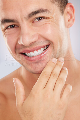 Buy stock photo Shot of a man touching his freshly shaved face