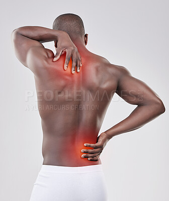 Buy stock photo Shot of a man experiencing back pain against a studio background