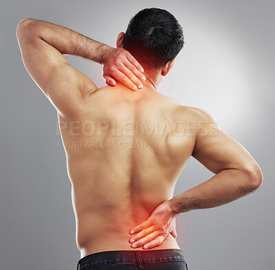 Buy stock photo Studio shot of a muscular unrecognizable man experiencing backache and neck pain against a grey background