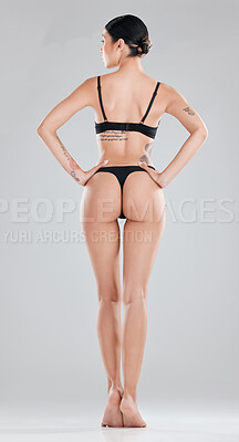Buy stock photo Full length shot of an unrecognisable woman standing and posing in lingerie in the studio