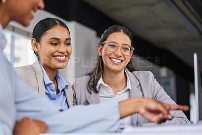 Buy stock photo Shot of businesswomen discussing something on a laptop