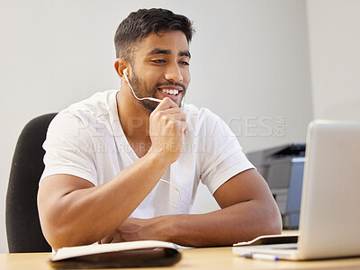Buy stock photo Shot of a handsome young man sitting alone and using his laptop for a video call while working from home