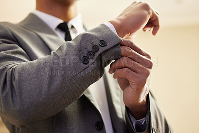 Buy stock photo Low angle shot of an unrecognizable young man adjusting his cuffs in the bedroom at home