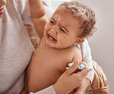 Buy stock photo Shot of a baby crying while having her temperature checked by her mother