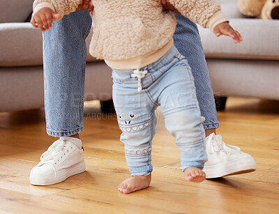 Buy stock photo Shot of a baby learning to walk with the help of his mother