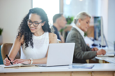 Buy stock photo Shot of a young businesswoman writing in a diary in an office at work