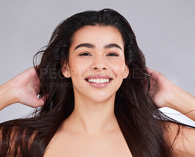Buy stock photo Studio portrait of an attractive young woman posing against a grey background