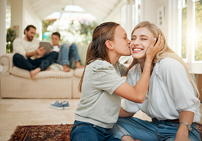 Buy stock photo Shot of a young girl kissing her mother on the cheek